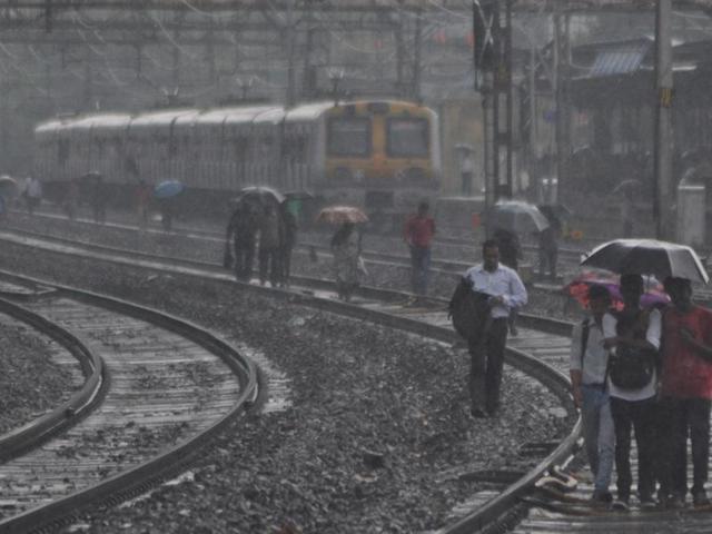 Train passengers often take the tracks to reach their destinations when technical failure brings the city’s lifeline to a halt. (Bhushan Koyande)