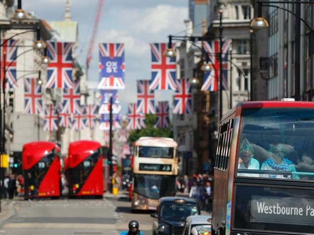 Buses travel along Oxford Street underneath Union flags in central London. (AFP) Buses travel along Oxford Street underneath Union flags in central London. (AFP)
