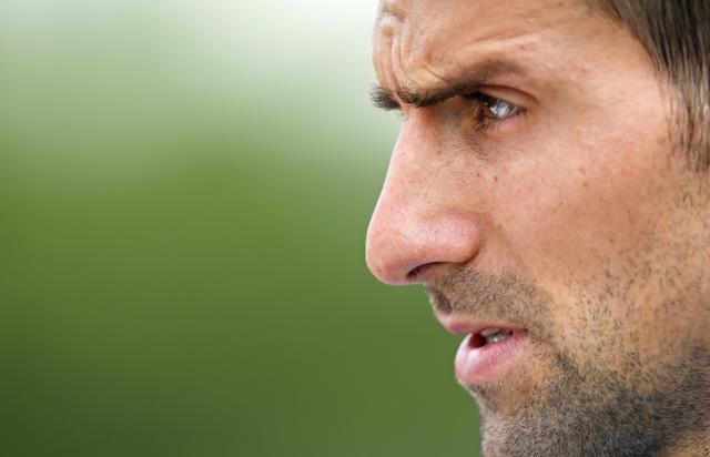 Novak Djokovic of Serbia grimaces after finishing a training session the day before the Wimbledon Tennis Championships in London. (AP) Novak Djokovic of Serbia grimaces after finishing a training session the day before the Wimbledon Tennis Championships in London. (AP)