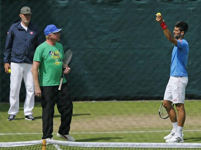 Novak Djokovic talks to coach Boris Becker, left, during a training session. (AP) Novak Djokovic talks to coach Boris Becker, left, during a training session. (AP)