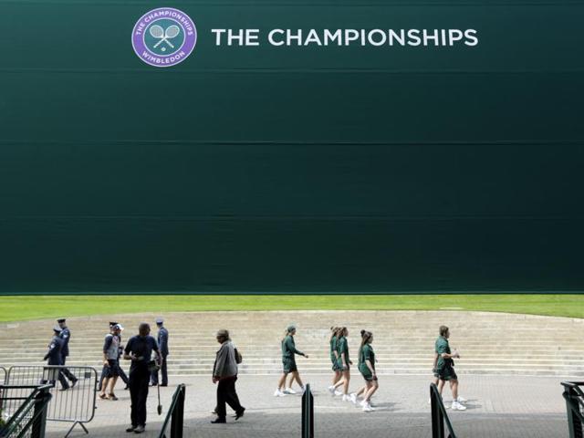 Staff members set up ahead of the start of The Championships. (AP) Staff members set up ahead of the start of The Championships. (AP)