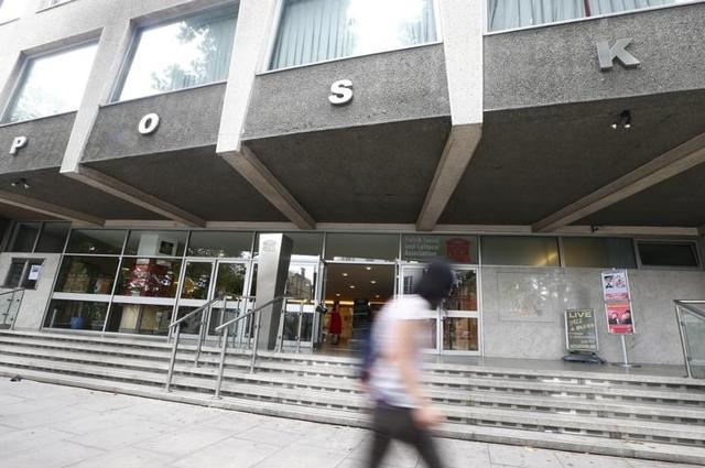 A pedestrian walks past the Polish Social and Cultural Association after graffiti was painted on the side of the building calling on Poles to leave the United Kingdom, in Hammersmith. (Reuters)
