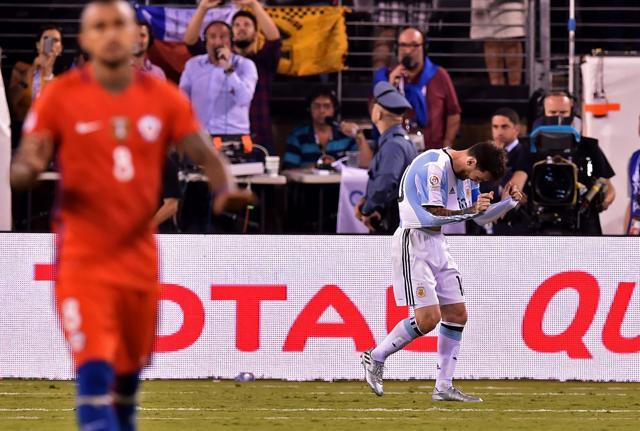 Messi vents his frustration on his jersey after missing his penalty. (AFP) Messi vents his frustration on his jersey after missing his penalty. (AFP)
