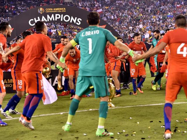 Chile's players hold hands and dance in celebration. (AFP)