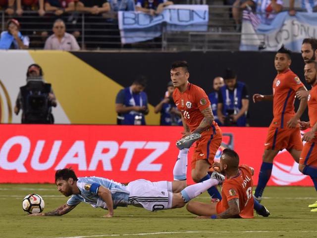 Lionel Messi (L) is brought down by Chile's Arturo Vidal. (AFP)