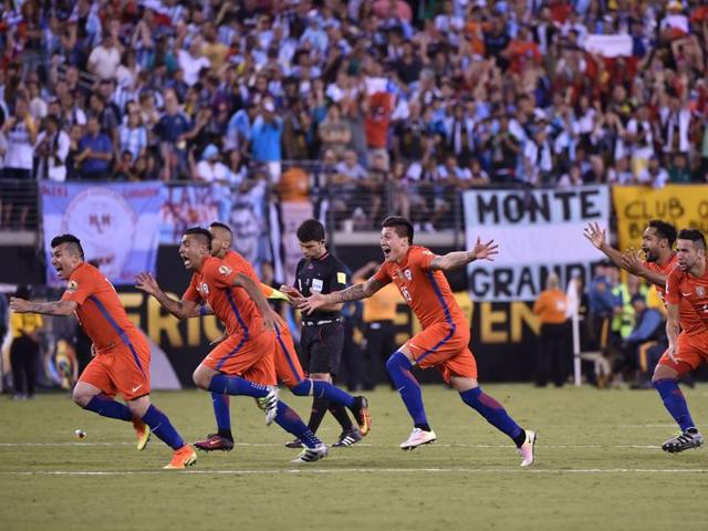Chilean players set off in celebration after the final penalty. (AFP)