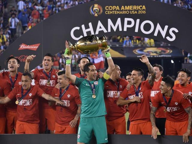 Chile's captain, goalkeeper Claudio Bravo, holds the trophy after winning the Copa America Centenario by defeating Argentina in the penalty shootout in East Rutherford, New Jersey, on June 26, 2016. (AFP)