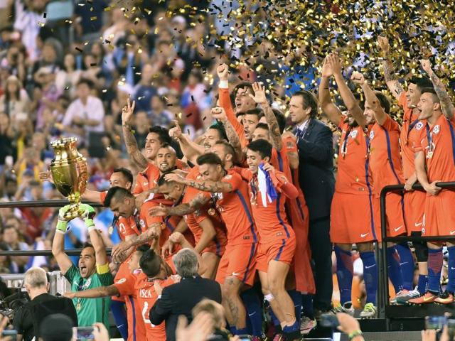Confetti falls as Chile, led by Claudio Bravo, celebrate their win. (AFP)