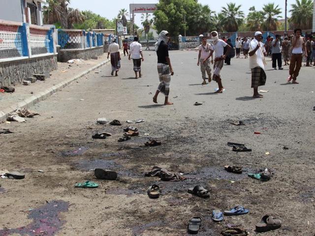 People walk at the site of a suicide bombing in the southern port city of Aden. (REUTERS File Photo) People walk at the site of a suicide bombing in the southern port city of Aden. (REUTERS File Photo)