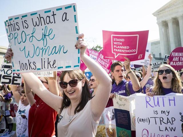 Pro-choice activists celebrate on the steps of the US Supreme Court in Washington on Monday. In a 5-3 decision, the Supreme Court struck down one of the nation's toughest restrictions on abortion, a Texas law that women's groups said would have forced more than three-quarters of the state's clinics to close. (AFP) Pro-choice activists celebrate on the steps of the US Supreme Court in Washington on Monday. In a 5-3 decision, the Supreme Court struck down one of the nation's toughest restrictions on abortion, a Texas law that women's groups said would have forced more than three-quarters of the state's clinics to close. (AFP)