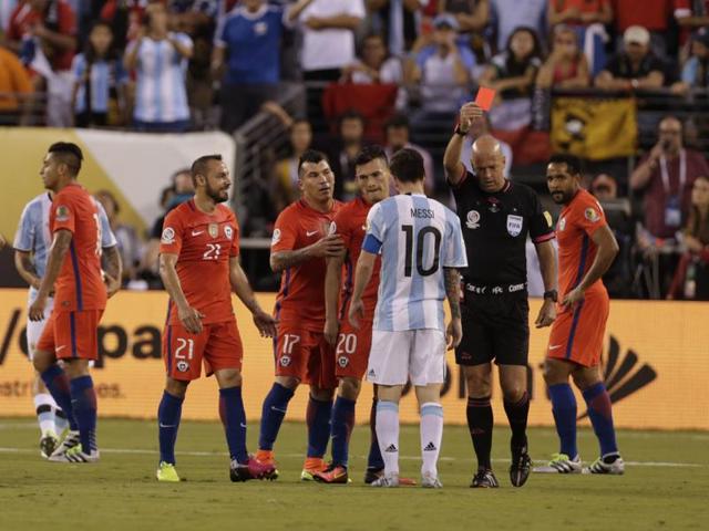 Referee Heber Lopes hands a red card to Chile midfielder Marcelo Diaz (21). (Reuters)