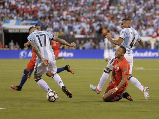 Chile forward Alexis Sanchez is brought down by Argentina defender Nicolas Otamendi (17). (Reuters)