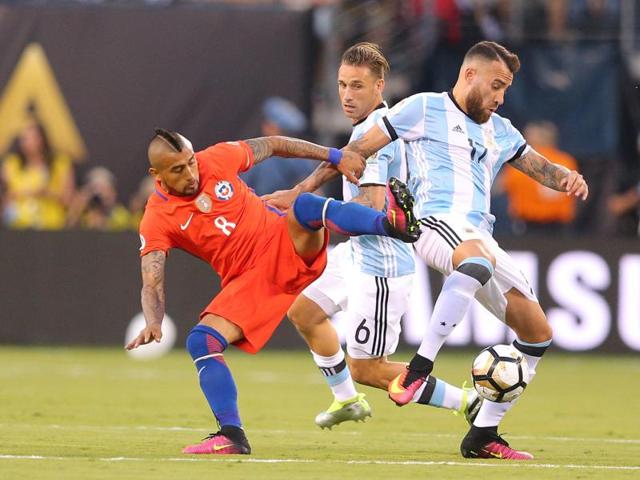 Argentina defender Nicholas Otamendi (17) battles for the ball with Chile midfielder Arturo Vidal (8). (Reuters)