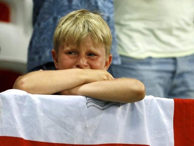 A young England fan cries at the end of the Euro 2016 round of 16 football match. (AP Photo)