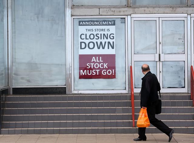 A man walks past a shop which has closed down in Redcar (AFP) A man walks past a shop which has closed down in Redcar (AFP)