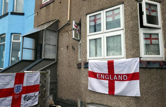 English Cross of St George flags hang outside a house in Redcar, north east England. (AFP) English Cross of St George flags hang outside a house in Redcar, north east England. (AFP)