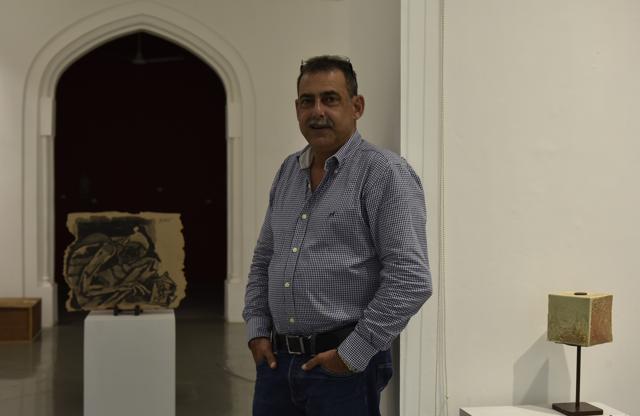 Dadiba Pundole, owner of Pundole's art gallery and auction house in Mumbai, India. On his right is an untitled Husain sketch from the 1990s. (Anshuman Poyrekar / HT Photo)