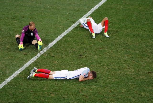 England's players dejected and in disbelief after the loss. (REUTERS)