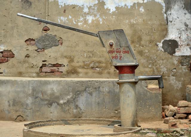 In this photograph taken on May 8, 2016, a water handpump with an inscription in Hindi which reads “This water is not fit for drinking water” stands in the village of Gangnauli in Uttar Pradesh. (AFP Photo)
