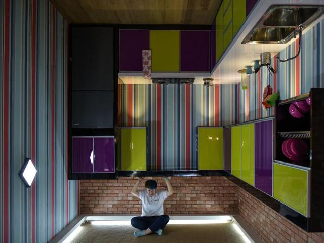 Here’s a woman enjoying herself in an upside-down kitchen. (AFP) Here’s a woman enjoying herself in an upside-down kitchen. (AFP)