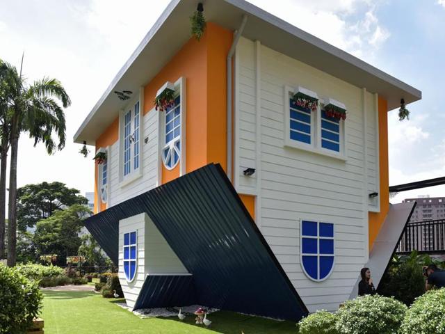 A tourist takes pictures outside the Kuala Lumpur Upside Down House at KL Tower. (AFP) A tourist takes pictures outside the Kuala Lumpur Upside Down House at KL Tower. (AFP)