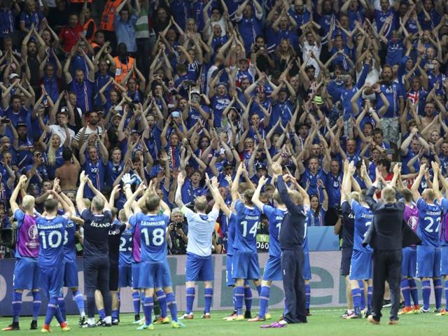 Iceland players celebrate with their supporters at the end of the Euro 2016 round of 16 football match between England and Iceland. Iceland, the smallest nation at the Euros, have reached the quarterfinals on their first appearance at a major international tournament. After their 1-1 draw against Portugal in the opener, Cristiano Ronaldo had controversially described the team as having a ‘small mentality’. (AP PHOTO)