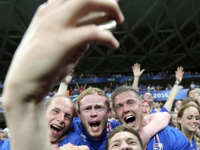 Iceland's Haukur Heidar Hauksson takes a selfie with supporters after a historic win. (AP PHOTO)