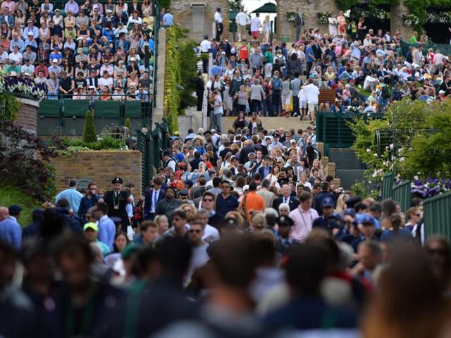 Spectators stream through the grounds of The All England Club. (AFP) Spectators stream through the grounds of The All England Club. (AFP)