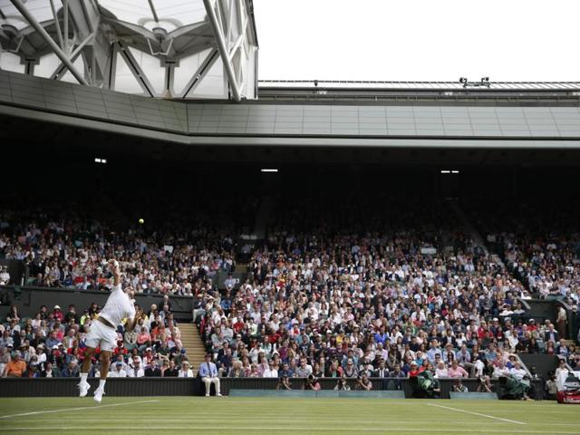 The crowd on Centre Court watches as Roger Federer serves. (AFP) The crowd on Centre Court watches as Roger Federer serves. (AFP)