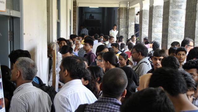 Students and guardians check cutoff lists at Delhi University. 