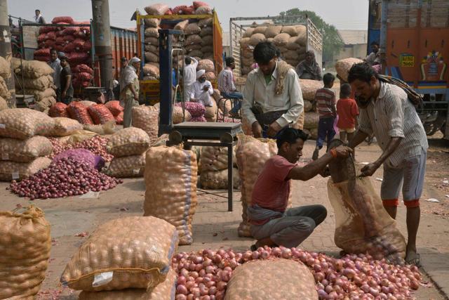 Indian labourers fill sacks with onions after sorting them at a wholesale vegetable and fruit market. Consumer confidence in India declined in the second quarter this year with concerns over fuel prices and rising inflation.(AFP) Indian labourers fill sacks with onions after sorting them at a wholesale vegetable and fruit market. Consumer confidence in India declined in the second quarter this year with concerns over fuel prices and rising inflation.(AFP)