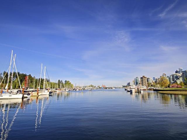 Best place to visit in Canada: Vancouver. In this photo, Vancouver scenic waterfront skyline with marina, yachts, people yakaking, Stanley Park and highrise coporate and condominium buildings along West Vancouver. * (iStockphoto)