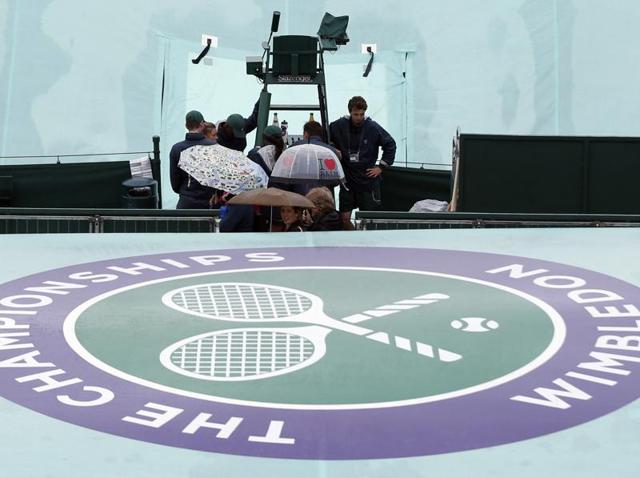 The covers are seen on the courts as rain delays play on day three of the Wimbledon Tennis Championships in London. (AP Photo) The covers are seen on the courts as rain delays play on day three of the Wimbledon Tennis Championships in London. (AP Photo)