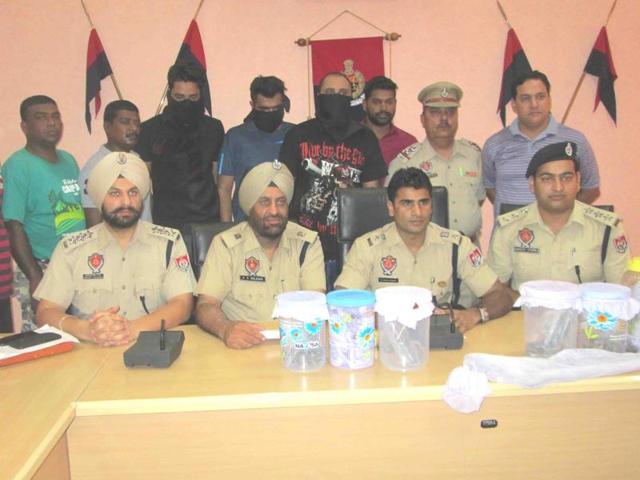 Hoshiarpur police officials showing the weapons and contraband seized from the murder accused in Hoshiarpur on Wednesday. (HT Photo) Hoshiarpur police officials showing the weapons and contraband seized from the murder accused in Hoshiarpur on Wednesday. (HT Photo)