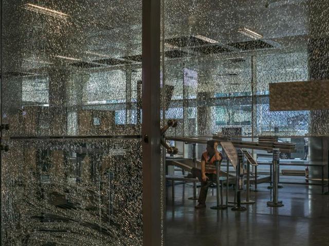 An employee sits at a security checkpoint near a damaged glass wall at the international terminal at the Ataturk Airport in Istanbul, June 29, 2016. (Agencies) An employee sits at a security checkpoint near a damaged glass wall at the international terminal at the Ataturk Airport in Istanbul, June 29, 2016. (Agencies)