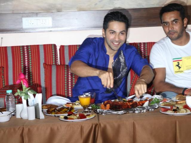 Varun Dhawan is quite excited to dig in the chicken pieces at Persian Darbar hotel during an Iftar party in Mumbai. (IANS)