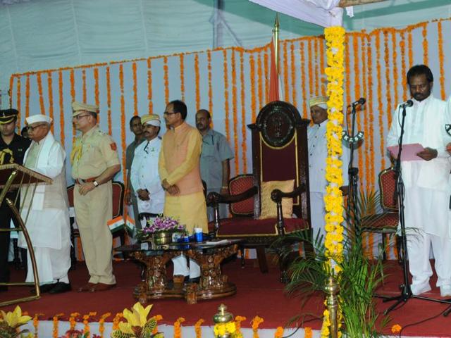 Governor Ram Naresh Yadav and chief minister Shivraj Singh Chouhan with the new ministers after the swearing in ceremony at Raj Bhavan in Bhopal on Thursday. (Praveen Bajpai/ HT photo) Governor Ram Naresh Yadav and chief minister Shivraj Singh Chouhan with the new ministers after the swearing in ceremony at Raj Bhavan in Bhopal on Thursday. (Praveen Bajpai/ HT photo)