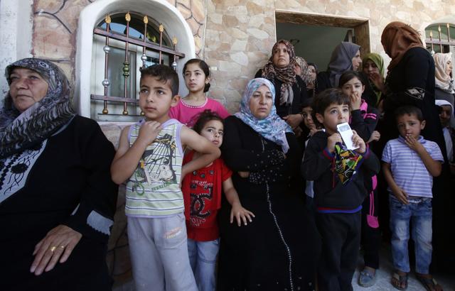 The family of Palestinian Mohammed Nasser Tarayra, who stabbed to death an Israeli teen in a Jewish settlement in the occupied West Bank on June 30,2016 is seen outside their family home in the village of Bani Naim, near the Palestinian city of Hebron. (AFP) The family of Palestinian Mohammed Nasser Tarayra, who stabbed to death an Israeli teen in a Jewish settlement in the occupied West Bank on June 30,2016 is seen outside their family home in the village of Bani Naim, near the Palestinian city of Hebron. (AFP)