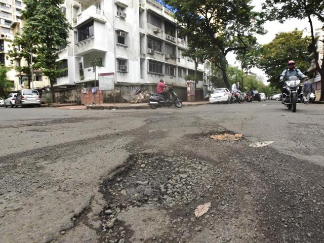 Matunga, near Starcity cinema: The pothole menace is spread far and wide. From western suburbs to Navi Mumbai, the cracks are showing up everywhere. (Kunal Patil/ Hindustan Times)
