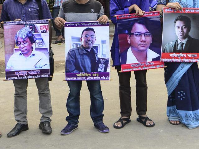 File photo of Bangladeshi activists holding photos of activists, writers and bloggers who were murdered by unidentified assassins in the last few years in Dhaka on June 15. (AFP) File photo of Bangladeshi activists holding photos of activists, writers and bloggers who were murdered by unidentified assassins in the last few years in Dhaka on June 15. (AFP)