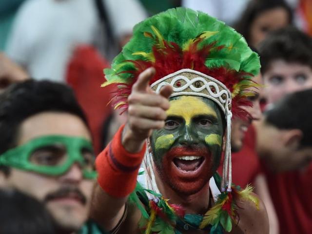 A Portugal supporter celebrates after they won the Euro 2016 quarterfinal football match against Poland.  (AFP Photo) 