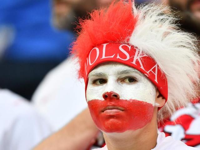 A Poland supporter reacts after the team lost the Euro 2016 quarterfinal football match against Portugal.  (AFP Photo) 