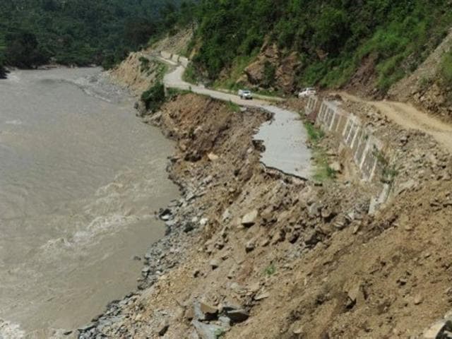 A truck is parked on a stretch of damaged road alongside the Mandakini river near Tilwara, in the flood affected area of Uttarakhand on July 1, 2013. (AFP File Photo) A truck is parked on a stretch of damaged road alongside the Mandakini river near Tilwara, in the flood affected area of Uttarakhand on July 1, 2013. (AFP File Photo)