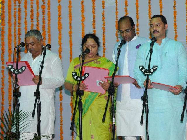 (From left) MLA Om Prakash Dhurve, Rustam Singh, Archana Chitnis and Jai Bhan Singh Pawaiya take oath as cabinet ministers at Raj Bhavan in Bhopal on Thursday. (Praveen Bajpai/ HT photo) (From left) MLA Om Prakash Dhurve, Rustam Singh, Archana Chitnis and Jai Bhan Singh Pawaiya take oath as cabinet ministers at Raj Bhavan in Bhopal on Thursday. (Praveen Bajpai/ HT photo)