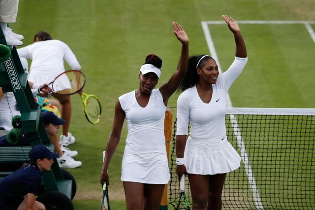 US player Serena Williams (right) and her partner US player Venus Williams (second right) wave to the crowd after beating Slovenia's Andreja Klepac and Katarina Srebotnik during their women's doubles first round match on the fourth day of the 2016 Wimbledon Championships. (AFP Photo) US player Serena Williams (right) and her partner US player Venus Williams (second right) wave to the crowd after beating Slovenia's Andreja Klepac and Katarina Srebotnik during their women's doubles first round match on the fourth day of the 2016 Wimbledon Championships. (AFP Photo)