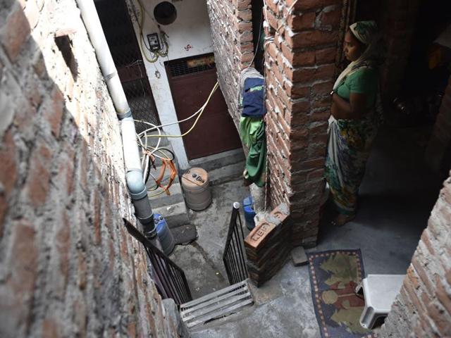 Neighbours peep outside to look at the house where a man killed his wife and daughter and committed suicide in Delhi’s Okha on Thursday night. (Saumya Khandelwal/Hindustan Times) Neighbours peep outside to look at the house where a man killed his wife and daughter and committed suicide in Delhi’s Okha on Thursday night. (Saumya Khandelwal/Hindustan Times)