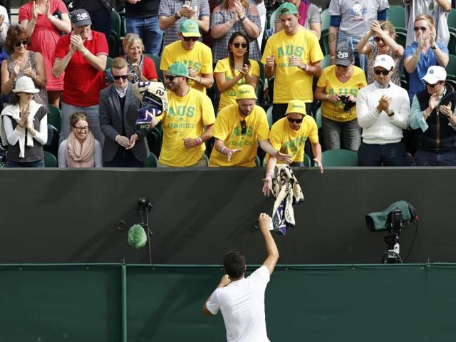 Australia's Bernard Tomic celebrates with fans after winning the match against Moldova's Radu Albot. (Reuters Photo) 