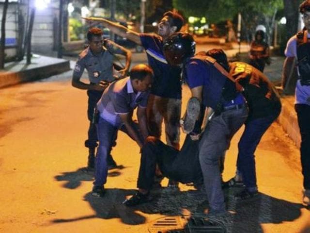 Bangladeshi security personnel stand guard near a restaurant that has reportedly been attacked by unidentified gunmen in Dhaka. (AP) Bangladeshi security personnel stand guard near a restaurant that has reportedly been attacked by unidentified gunmen in Dhaka. (AP)