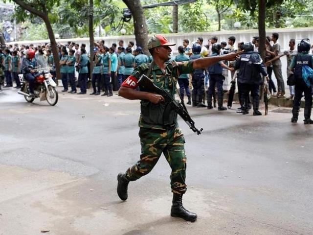 A securityman reacts near the Holey Artisan restaurant after gunmen attacked the upscale cafe in Dhaka.(Reuters) A securityman reacts near the Holey Artisan restaurant after gunmen attacked the upscale cafe in Dhaka.(Reuters)