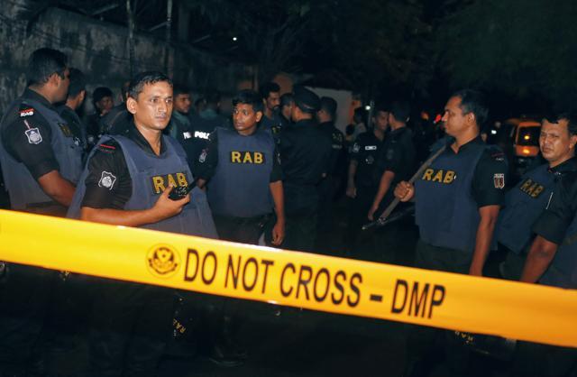 Bangladeshi security officers cordon off an area after heavily armed militants attacked a restaurant in Bangladesh's diplomatic zone on Friday night. (AP)